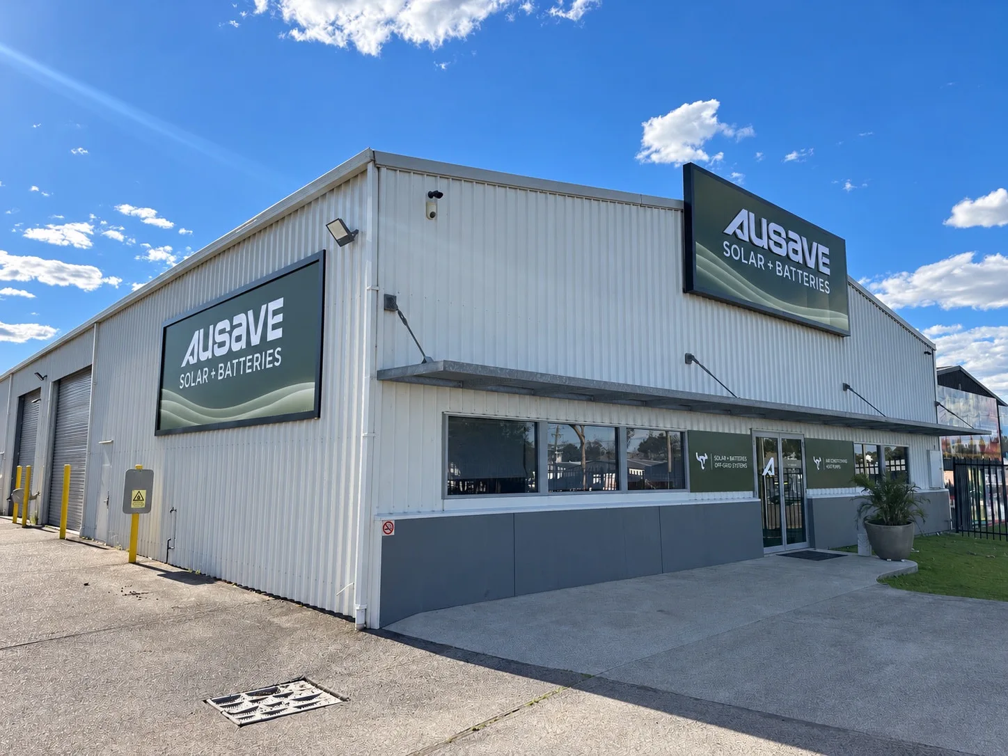 Wide corner view of the Ausave premises and building signage