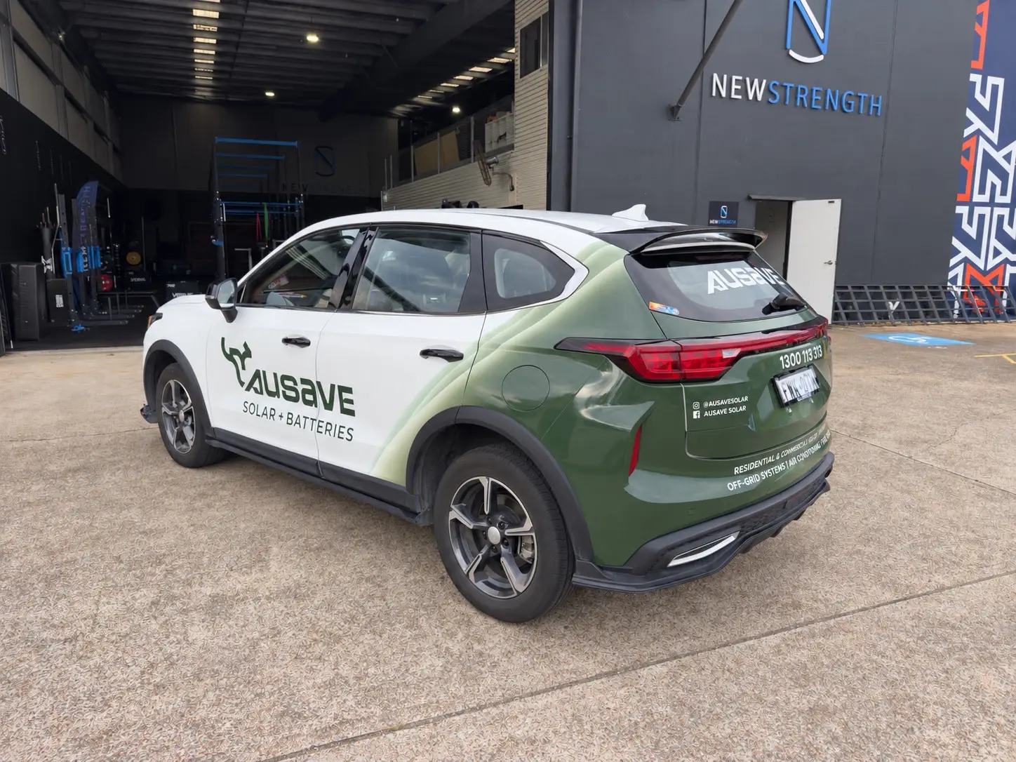 Ausave branded SUV with vehicle graphics on the side and rear