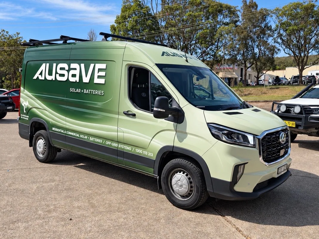 Ausave branded van in green and white livery, parked on a concrete lot