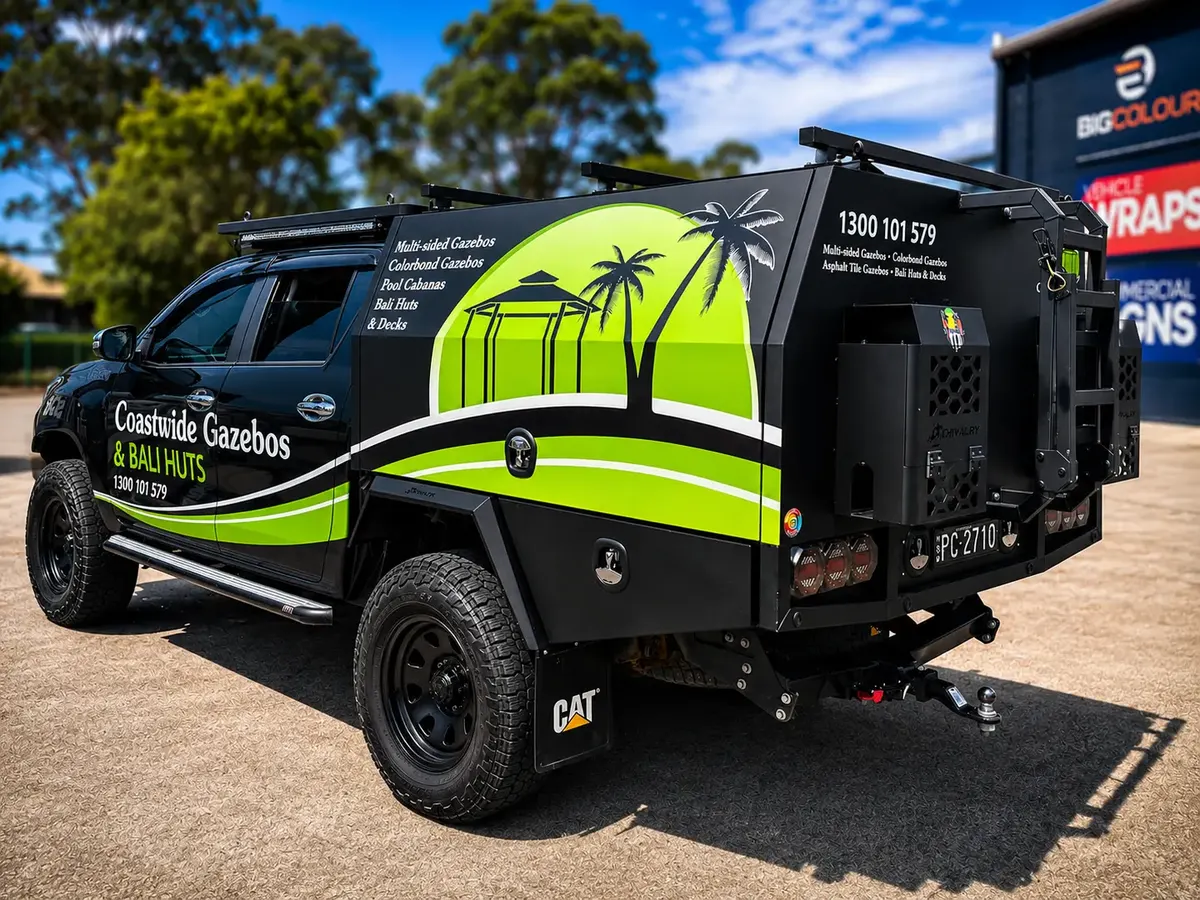 Coastwide Gazebos and Bali Huts dual-cab ute wrapped in black with lime green and white palm tree graphics across the doors and tray canopy