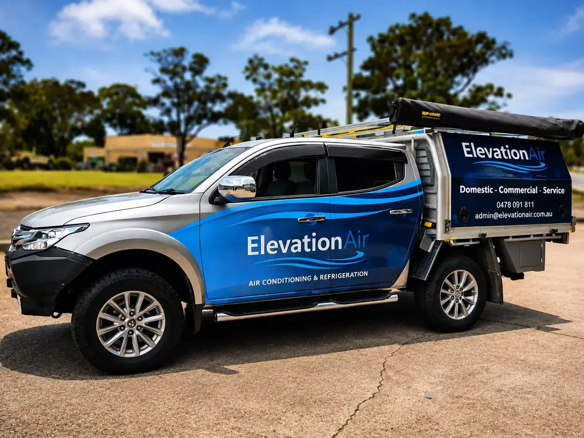 Elevation Air blue and silver Chevrolet ute with custom signage wrapped by Big Colour
