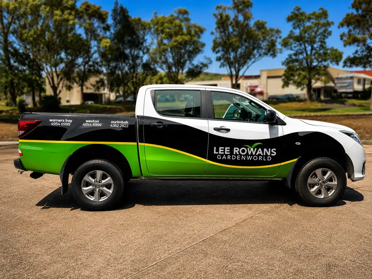Lee Rowans Gardenworld dual-cab ute wrapped in white, black and green with the store phone numbers along the tub