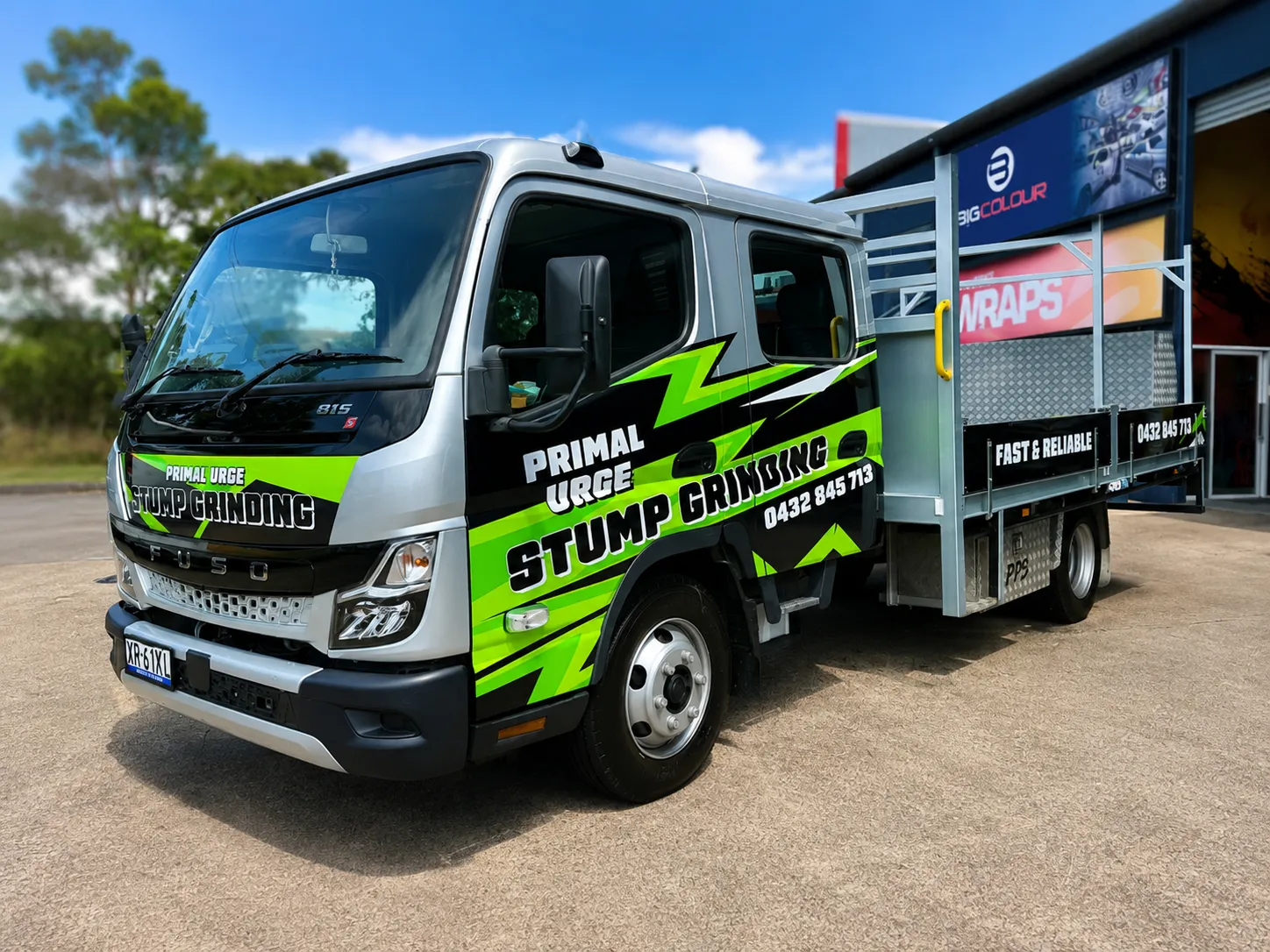 Primal Urge Stump Grinding truck signage in white and green