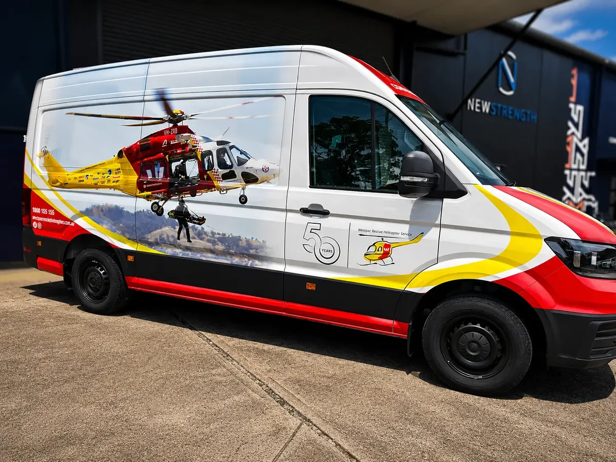 Westpac Rescue Helicopter Service van wrapped by Big Colour, right side with the winch rescue photograph running the length of the body and the 50 Years mark beside the sliding door