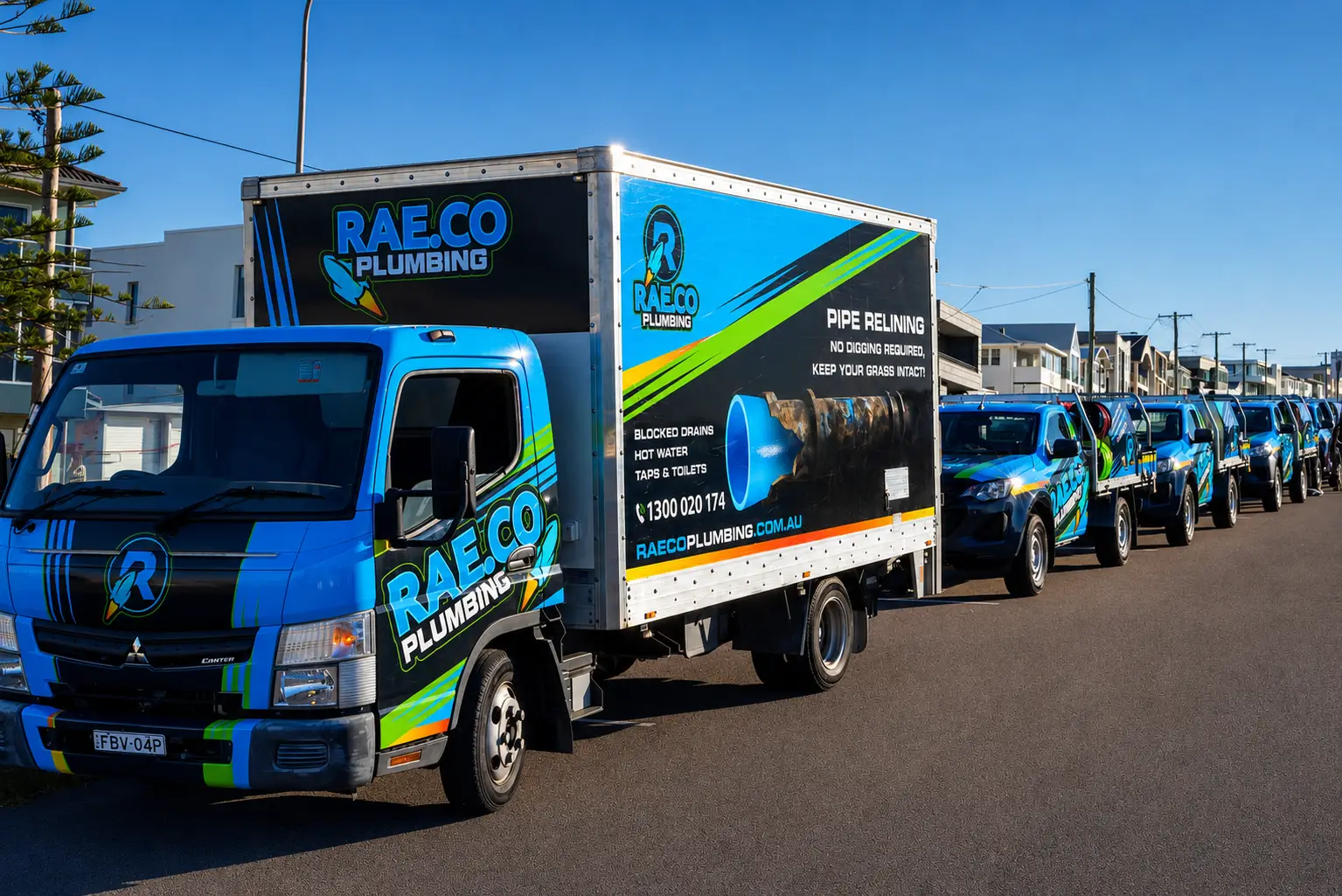 RAE.CO Plumbing fleet of wrapped trucks, trailer and vans lined up outdoors in bright blue, black and lime green livery