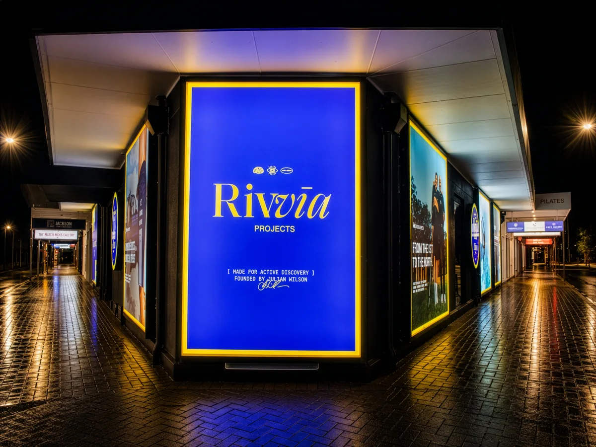 Rivvia Projects corner lightbox displays glowing at night