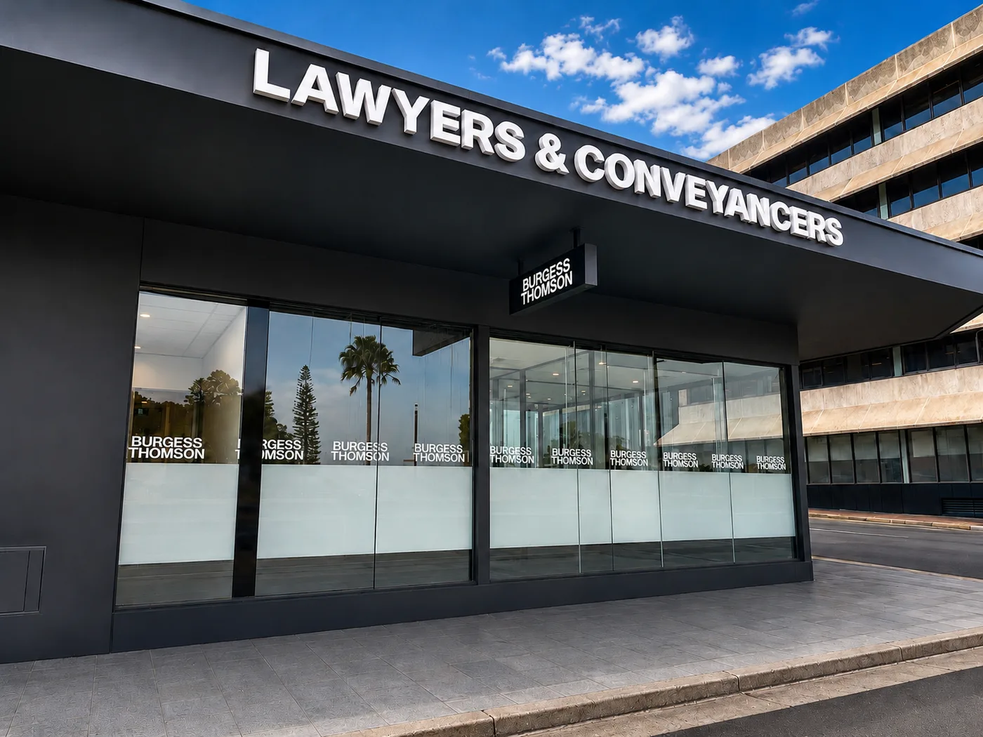 Burgess Thomson Lawyers & Conveyancers storefront with black fascia signage and frosted glass windows
