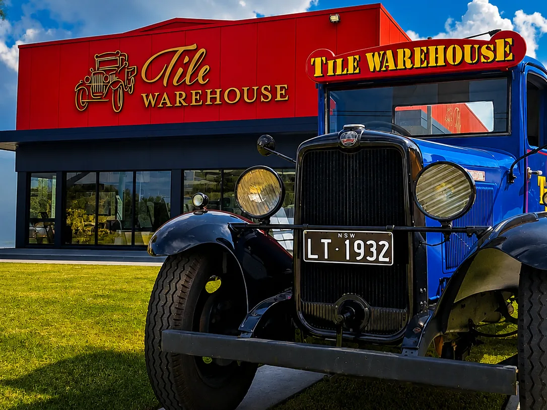 Tile Warehouse building signage in red and blue, with their vintage 1932 truck out front