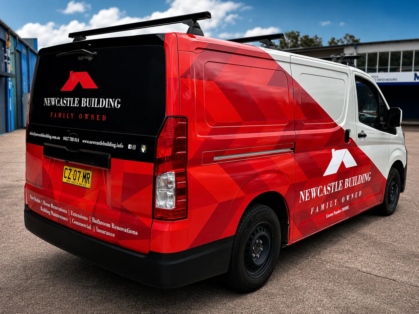 Red and white wrapped Newcastle Building service van with full-colour livery and contact details