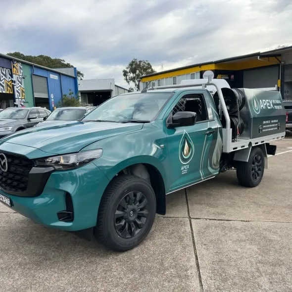 Front three-quarter of the teal Apex Plumbing Projects ute showing the colour fade across the cab