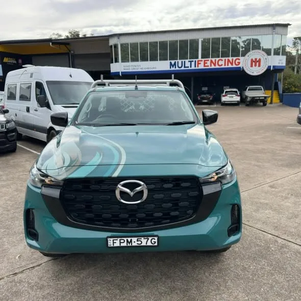 Head-on view of the wrapped Apex Mazda ute, teal bonnet with a lighter swoosh over the grille