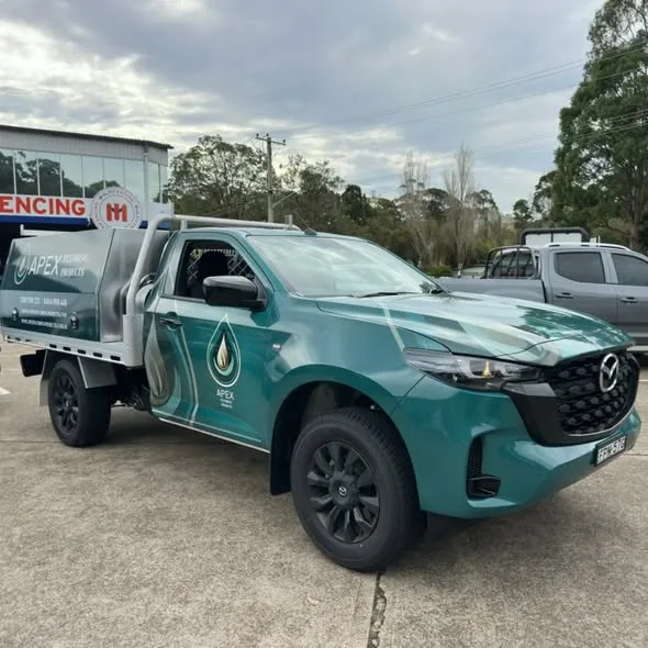 Apex Plumbing Projects ute from the tray side, white water tank fitted behind the cab