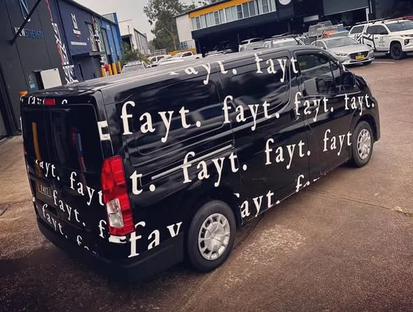 Rear of the FAYT van covered in the repeating fayt logotype