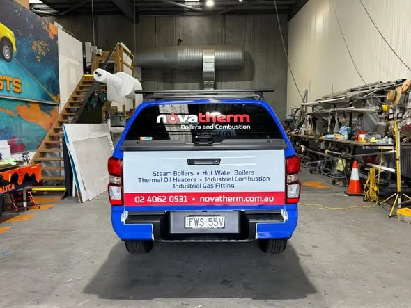 Blue Novatherm service vehicle being lettered inside the Big Colour workshop
