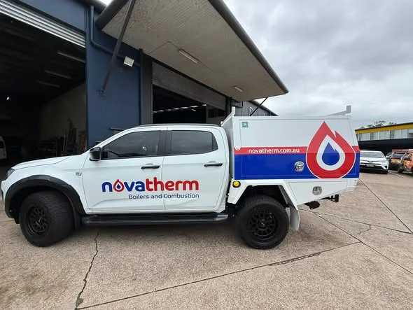 Novatherm ute side profile, roof racks fitted, branding along the tray