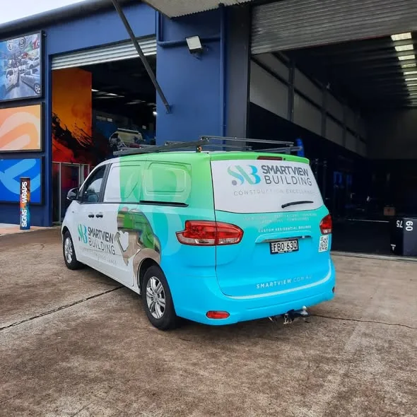 Smartview Building van parked at the Big Colour workshop, rear three-quarter view of the finished wrap