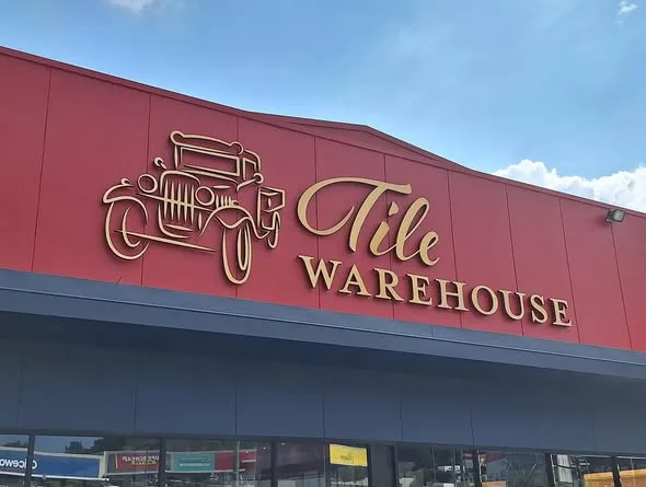 Gold Tile Warehouse lettering across the long red awning fascia