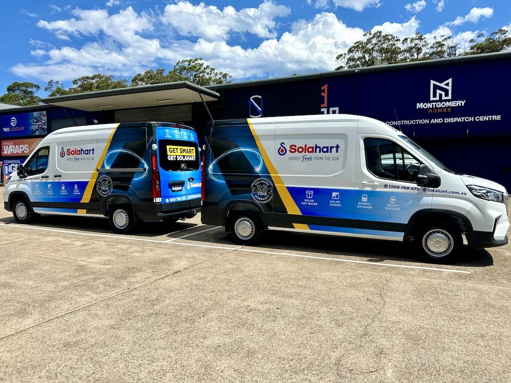 Two Solahart vans in blue, white and yellow full wraps parked side by side