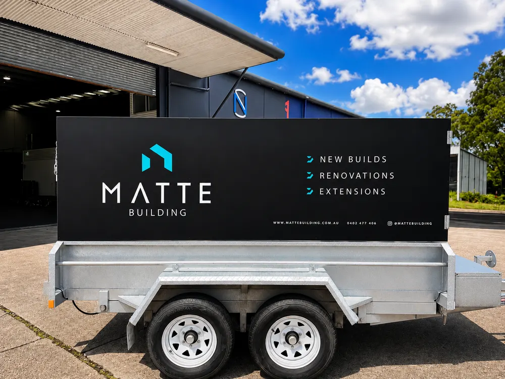 Matte Building utility trailer wrap with services down the side