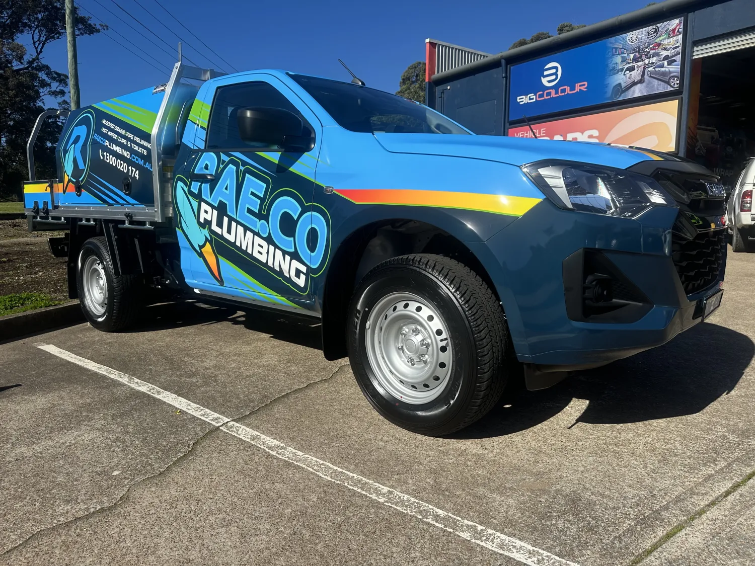 RAE.CO Plumbing truck signwritten by Big Colour in blue and yellow with contact details on the side