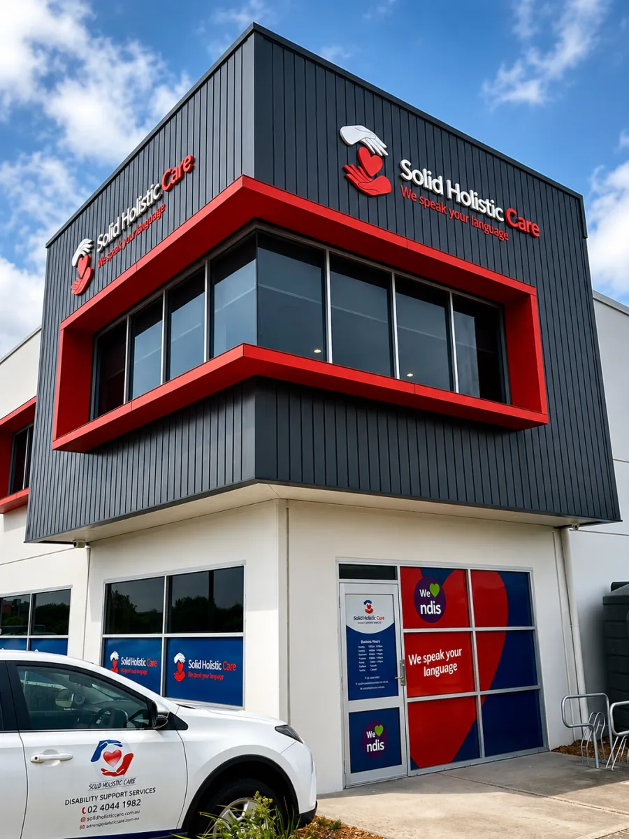 Solid Holistic Care building signage in red and grey, made and installed by Big Colour