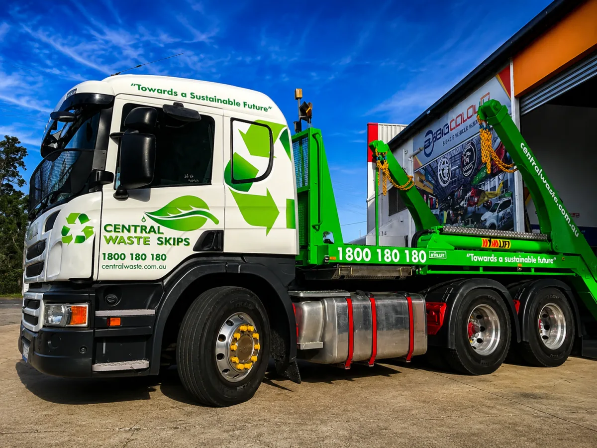Central Waste Skips skip loader truck in white and green with recycling graphics