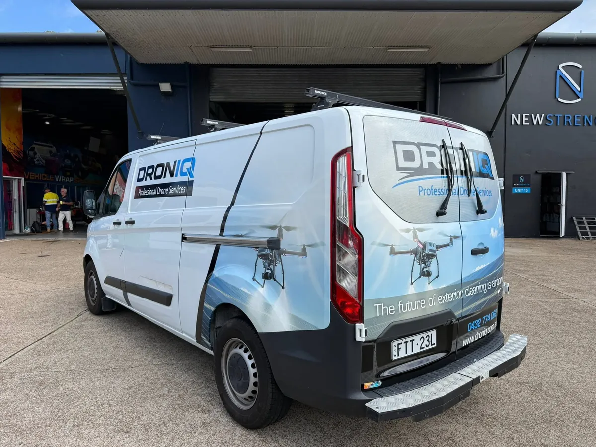 Compact white van with minimal cut-vinyl branding