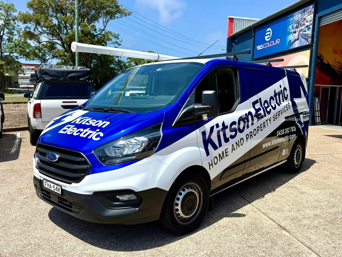 Kitson blue Transit van with side branding