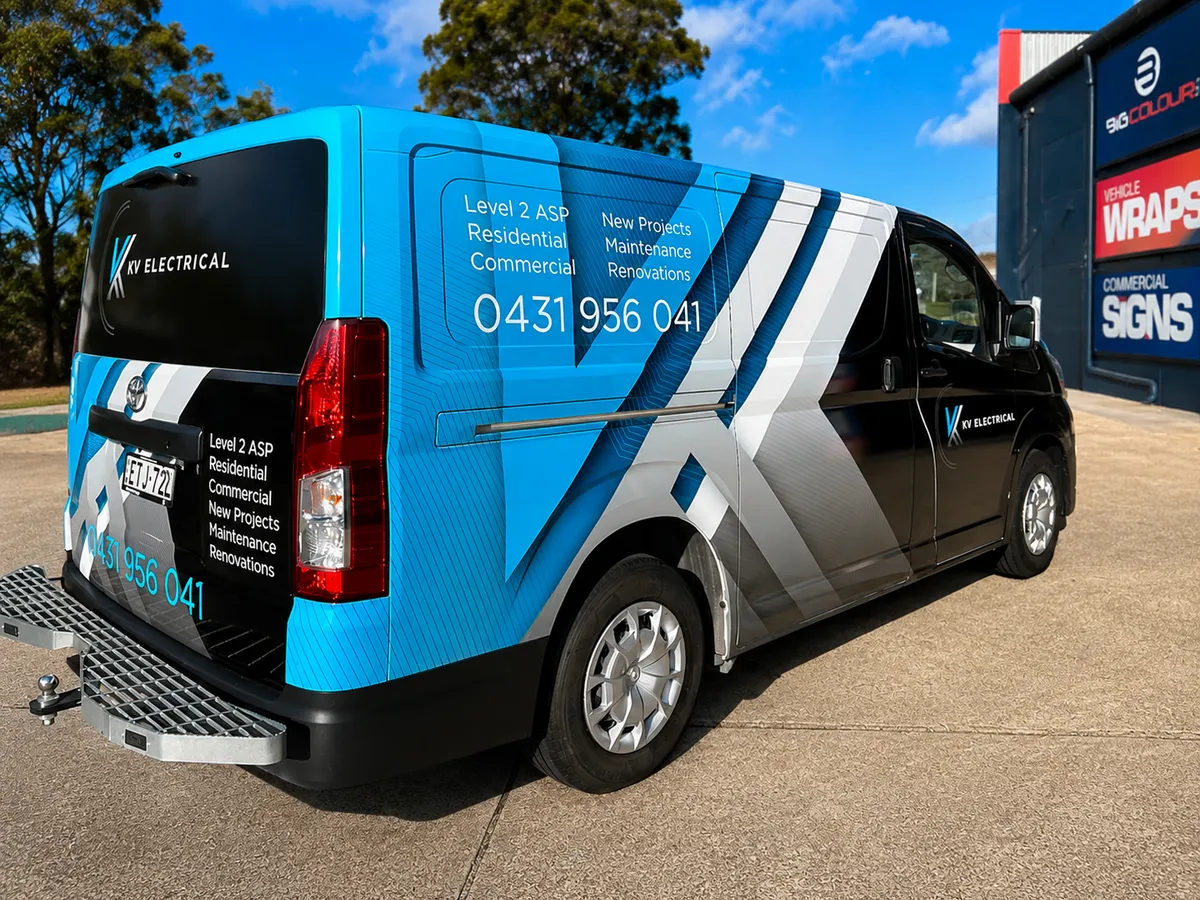 KV Electrical van in the black and bright blue geometric wrap, rear view