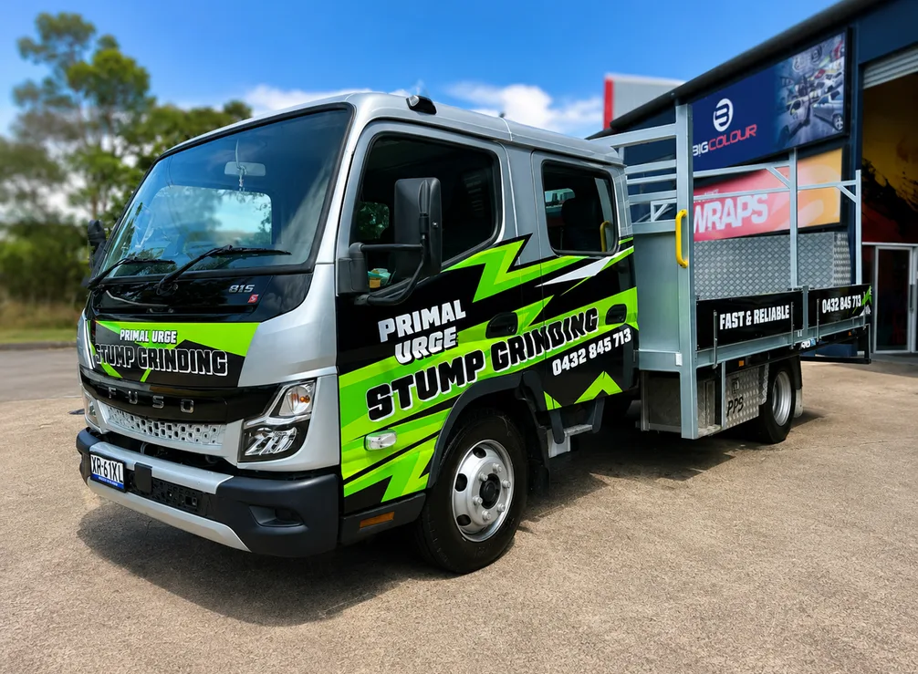 Primal Urge Stump Grinding crew-cab tray truck with black and lime green lettering