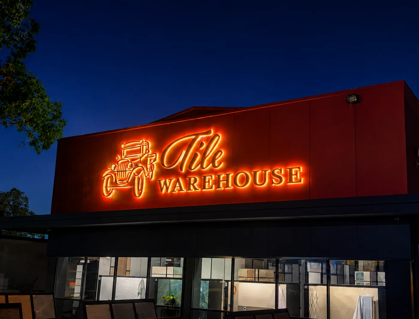 Tile Warehouse illuminated shopfront sign at dusk, made and installed by Big Colour