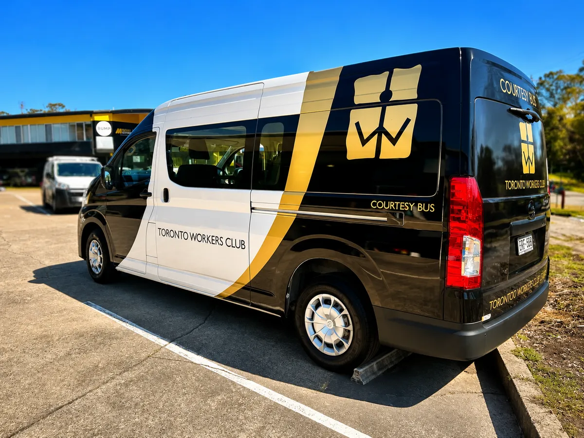 Toronto Workers Club courtesy bus in the black, white and gold wrap