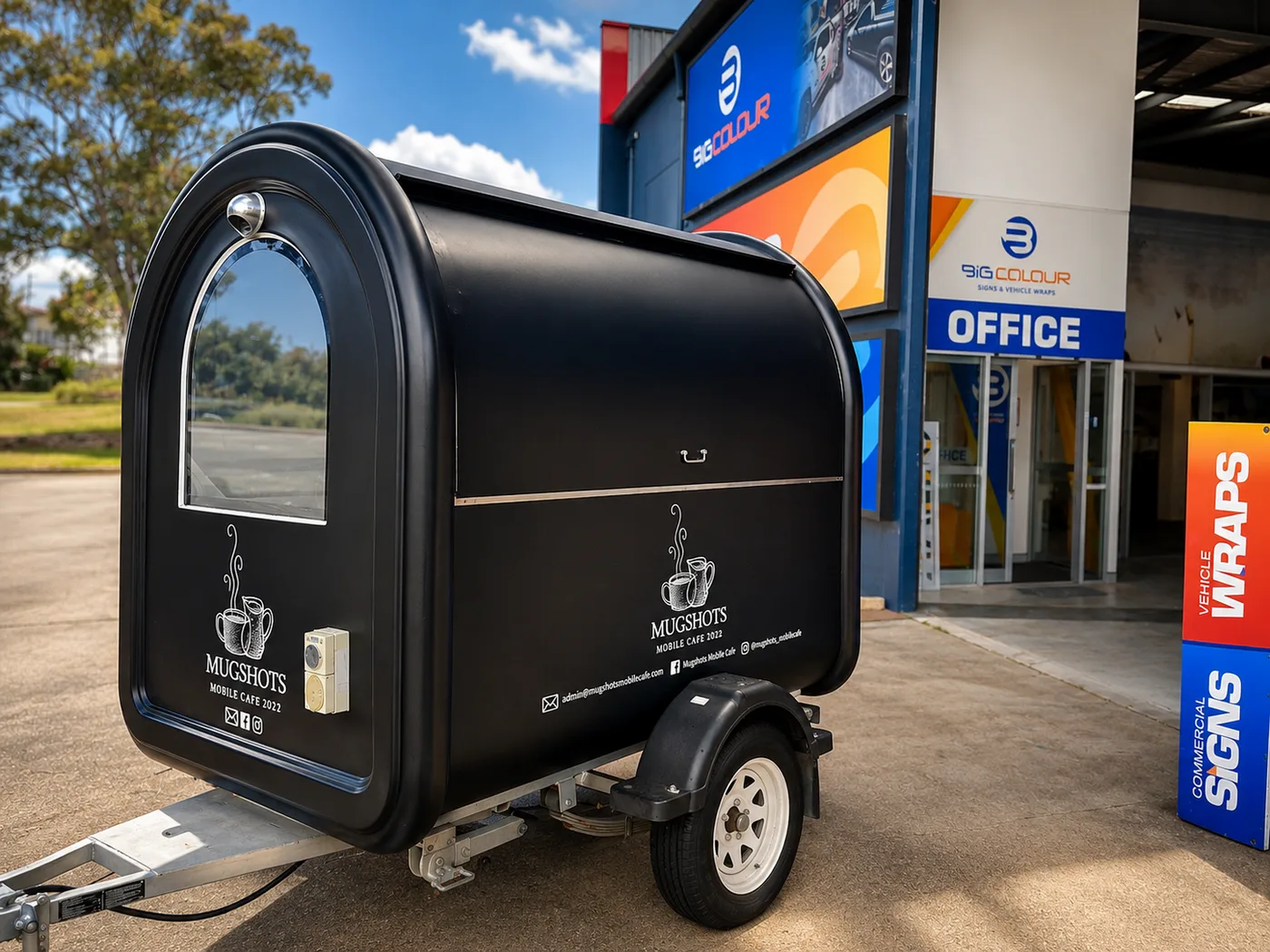 Black teardrop coffee trailer with branding