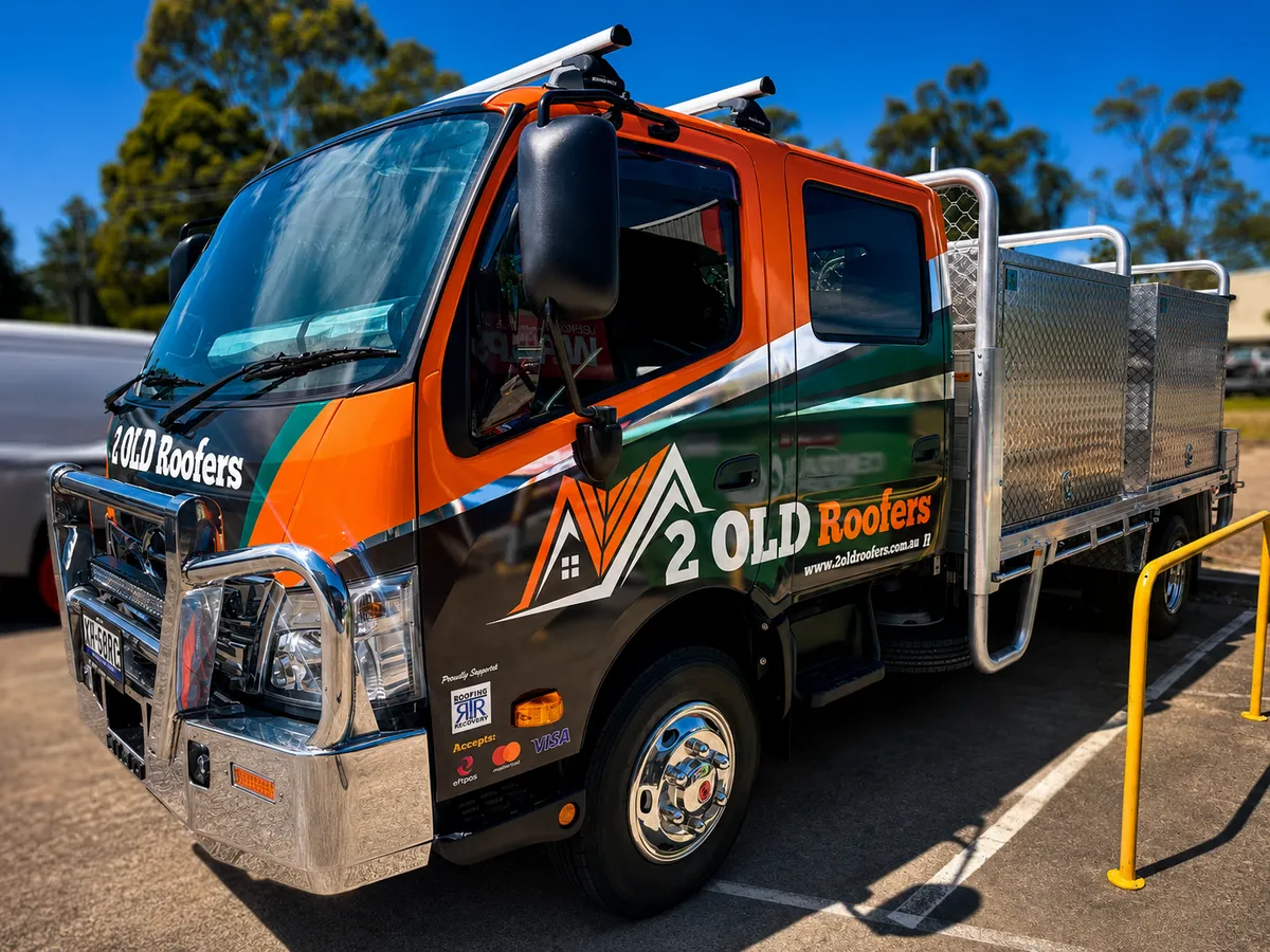 2 Old Roofers service truck in orange and green branding, wrapped by Big Colour