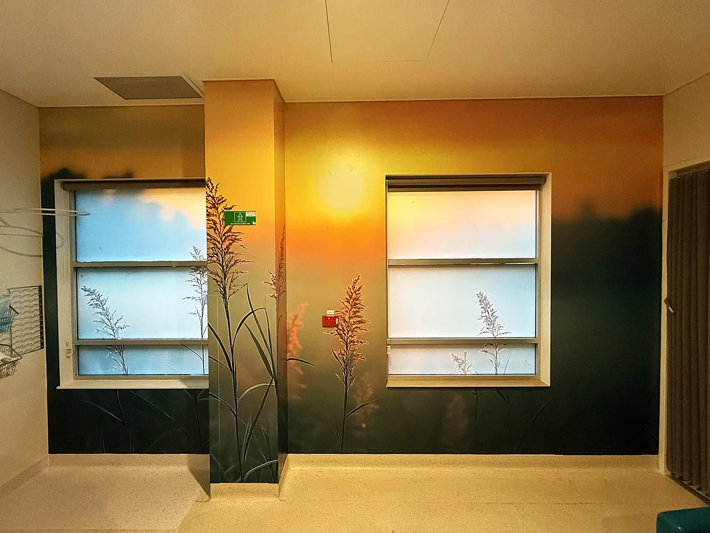 Two backlit nature-scene light panels along an office hallway