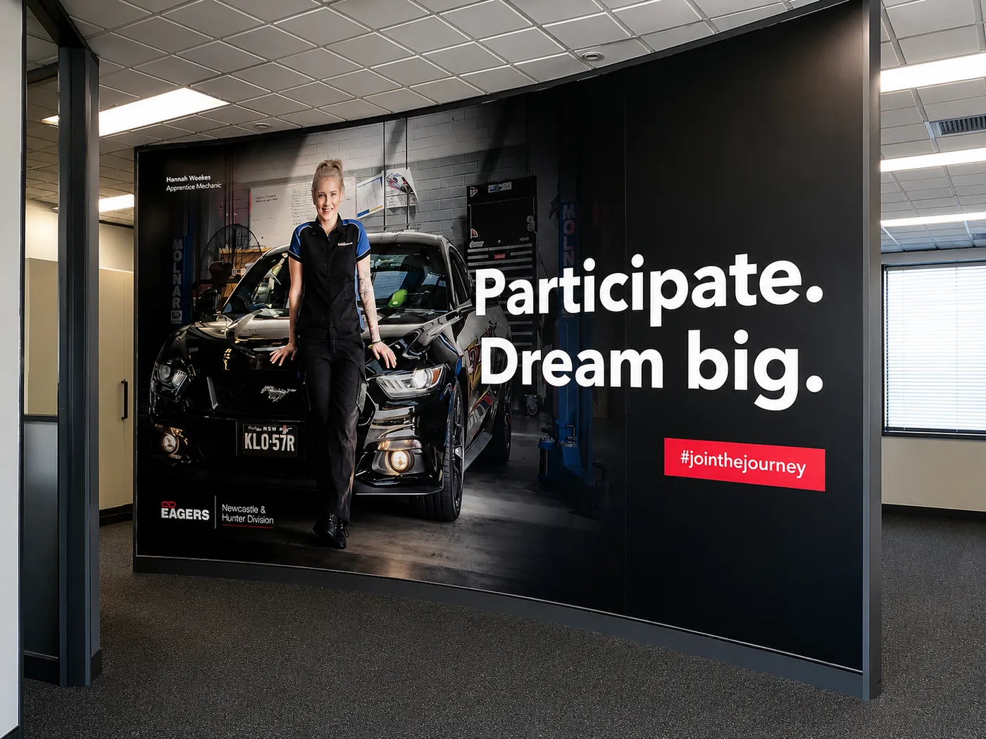 Recruitment campaign photo wall installed in a dealership workshop by Big Colour