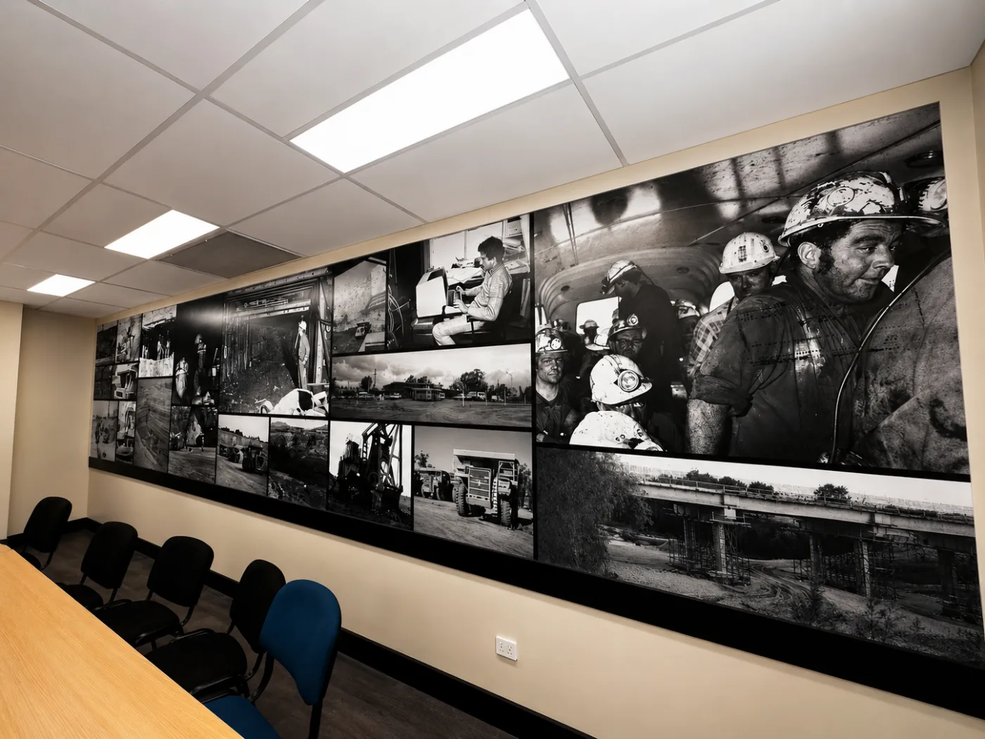 Black and white mining photo mural installed in a conference room
