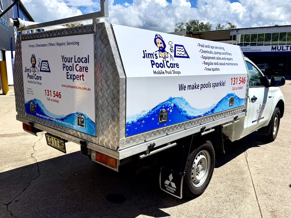 Jim's Pool Care ute with blue and white printed graphics across the canopy